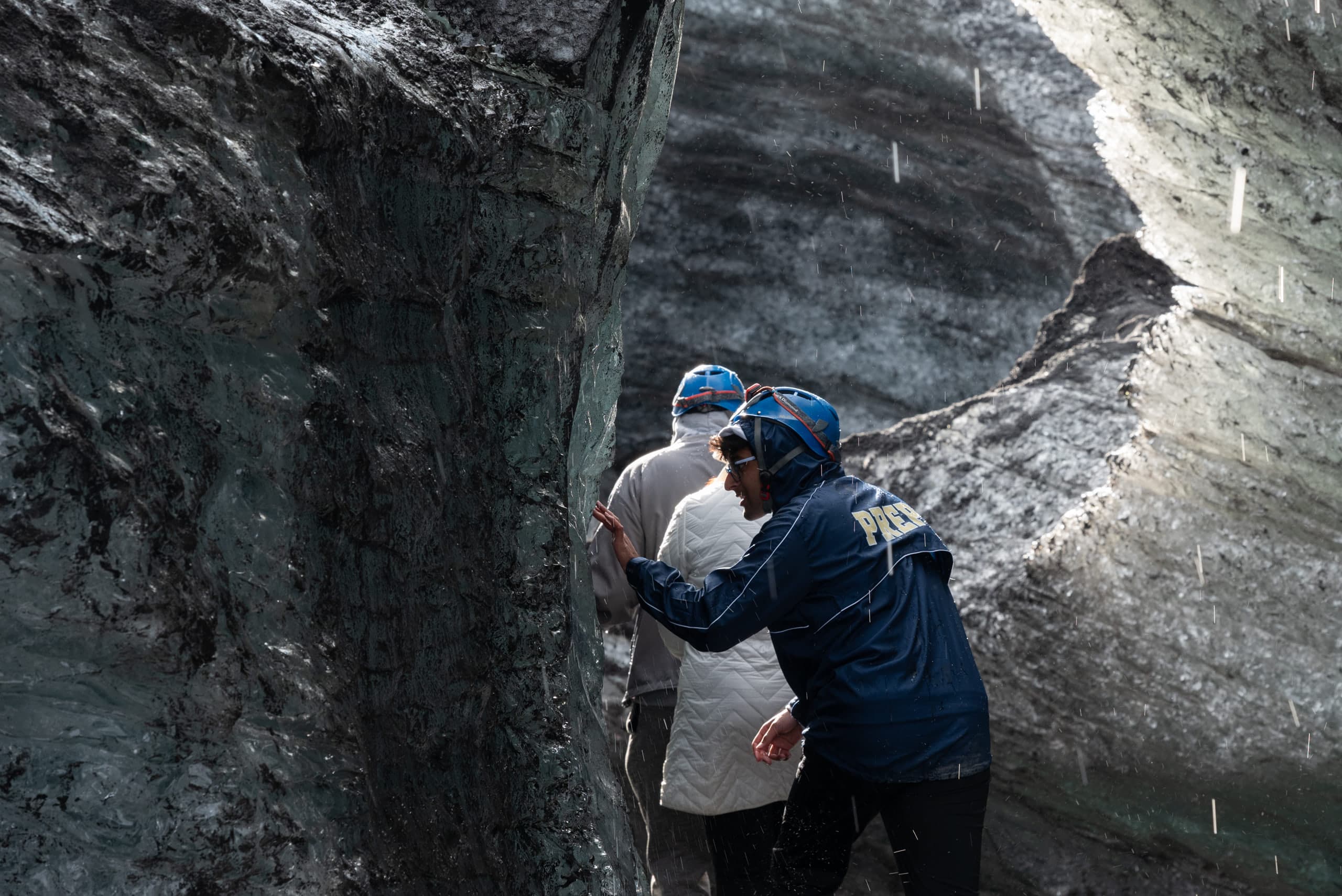 A teenager touching the wall of an ice cave